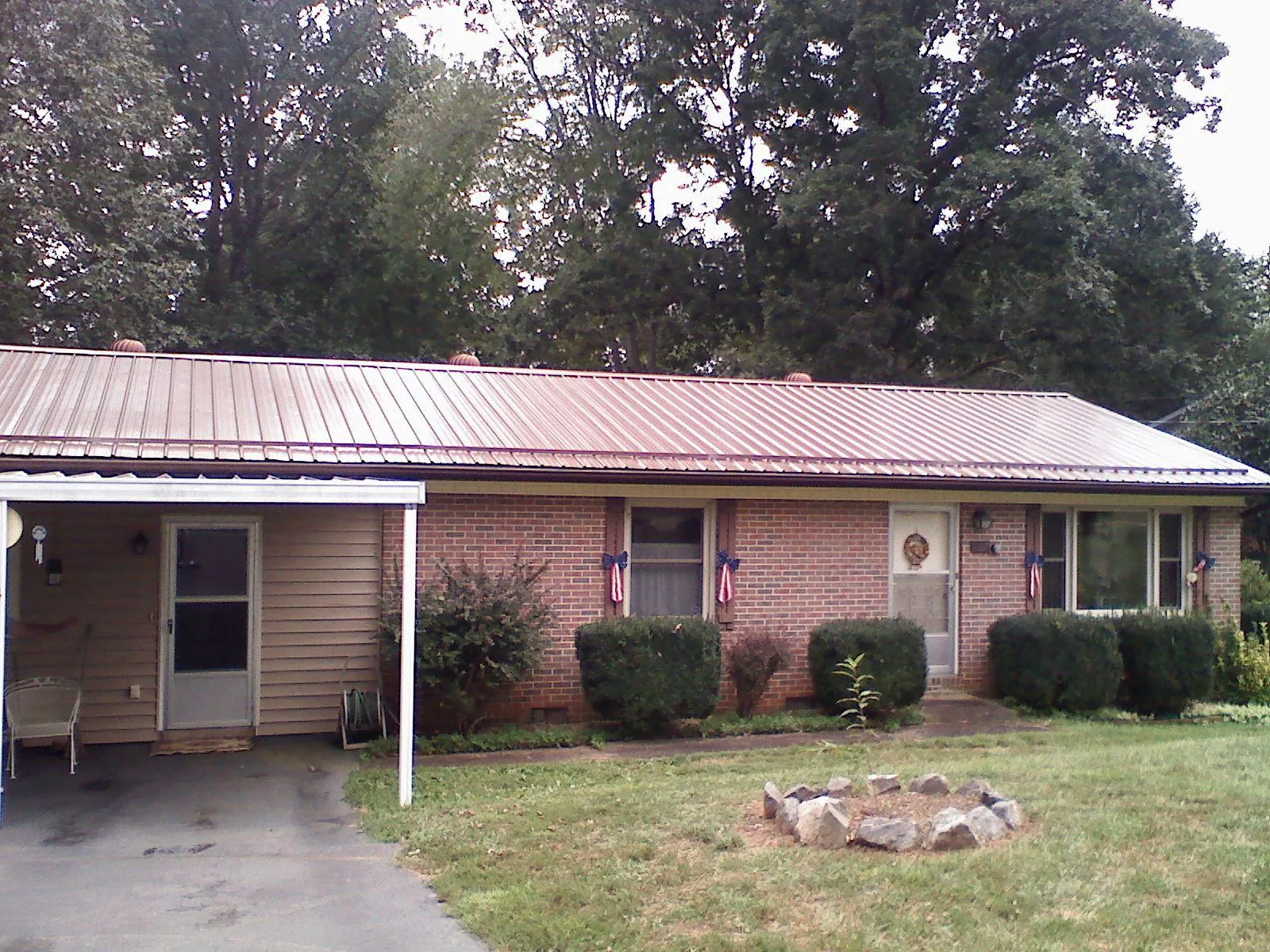 Bronze metal roof and carport on a brick ranch home — Roof Repair work by our crew in Vernalis